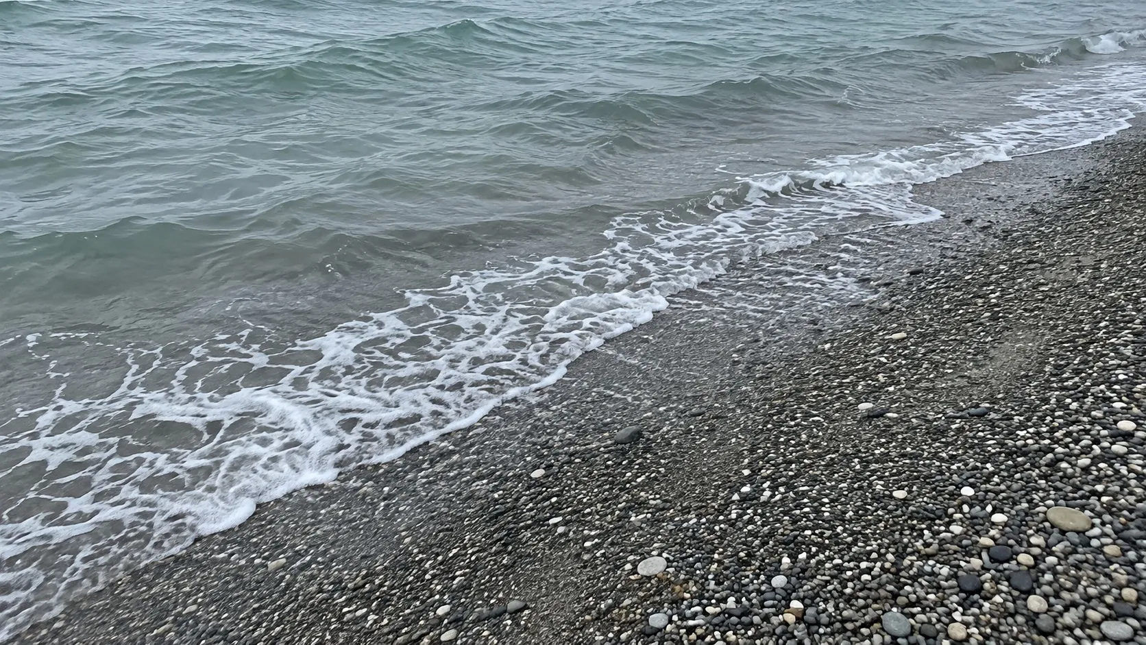 Мелкая вода у песчаного берега: на дне видна рябь песка (иллюстрация)